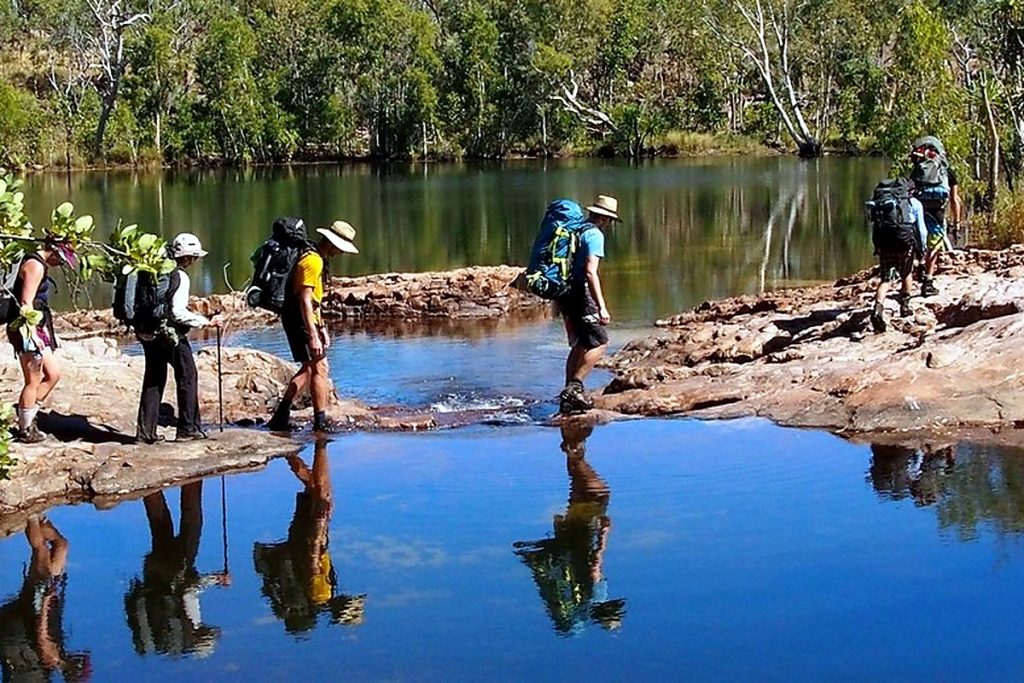 Walkers crossing a creek on the Jatbula Trail