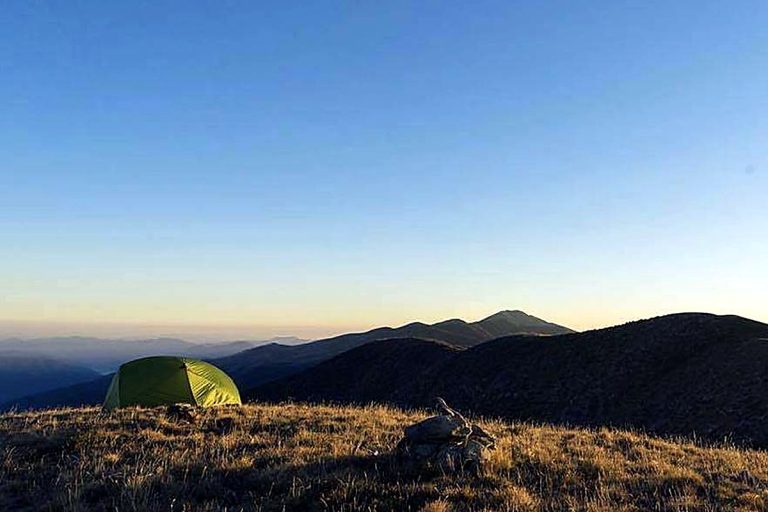 Two-person tent on an exposed hilltop